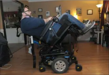  ?? PHOTOS BY GENE WALSH - MEDIANEWS GROUP ?? James Myers works on his computer in his wheelchair that is tilted to relieve pressure on his spine February 6, 2019.