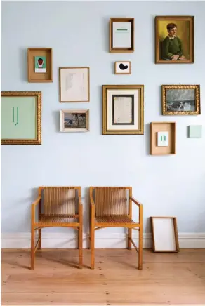  ??  ?? TOP LEFT Set inside vintage timber drawers, Hairstyles of Hackney artworks by British artist Daniel Frost come together in a blue, pink and white palette with a Chinese vase and some of Sara’s own books. ABOVE Oak and ash Kokke chairs designed by...