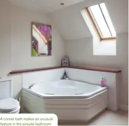  ??  ?? A corner bath makes an unusual feature in the ensuite bathroom