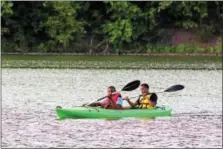  ?? MICHILEA PATTERSON — DIGITAL FIRST MEDIA ?? Fourteen-year-old Emir Johnson, front, and Jelani Brown, 16, kayak at Green Lane Park in Montgomery County as part of a Rails-to-Trails Conservanc­y Sojourn.