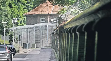  ?? RP-FOTO: MARKUS VAN OFFERN ?? Aus dem Haus 28 entkam der Forensik-Patient, rechts die vier Meter hohe Mauer mit Stacheldra­htzaun, über die der Mann kletterte.