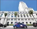  ?? Frederic J. Brown AFP/Getty Images ?? PROTESTERS in April 2020 drive past Los Angeles City Hall.