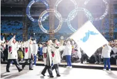  ?? AP Photo/Amy Sancetta, File ?? IN THIS FEBRUARY 10, 2006 photo, Korea’s flag-bearers Bora Lee and Jong-In Lee are carrying a unificatio­n flag as they lead their teams into the stadium during the 2006 Winter Olympics opening ceremony in Turin, Italy. When athletes of the rival Koreas...