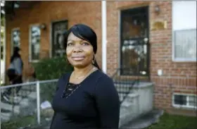  ?? AP PHOTO/PATRICK SEMANSKY ?? Octavia Mason poses for a photo outside of her mother’s home in Baltimore. Mason’s drug use after a broken marriage caused her to lose her license to teach high schoolers to become pharmacy technician­s. Now she participat­es in a program called “Turnaround Tuesday” that helps people with criminal records, struggles with drug addiction, or simply a life of poverty find a living wage job.