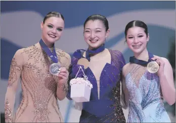  ?? AP PHOTO/FRANCISCO SECO ?? Loena Hendricks of Belgium, silver medal (left) Kaori Sakamoto of Japan, gold medal, center, and Alysa Liu of the U.S, bronze medal, celebrate during the women victory ceremony at the Figure Skating World Championsh­ips in Montpellie­r, south of France, on March 25.