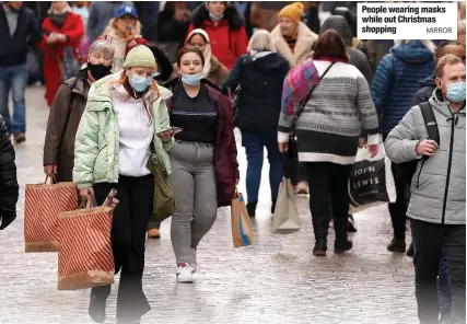  ?? MIRROR ?? People wearing masks while out Christmas shopping