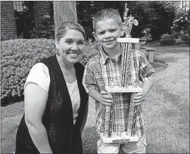  ?? REPOSITORY] [CHARITA GOSHAY/THE CANTON ?? Isaac Williamson, with his mom, Andrea, has a room full of trophies that he’s won as a state motocross champion.