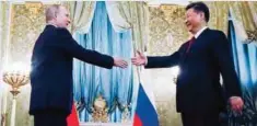  ??  ?? MOSCOW: Russian President Vladimir Putin (left) shakes hands with Chinese President Xi Jinping during a meeting in the Kremlin, in Moscow yesterday. Chinese President is on a two-day official visit in Moscow. —AP