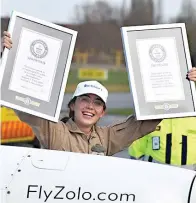  ?? Associated Press ?? ■ Zara Rutherford holds up her certificat­es after landing her Shark ultralight plane Thursday at the Kortrijk airport in Kortrijk, Belgium. The 19-year-old Belgian-British pilot has set a world record as the youngest woman to fly solo around the world, touching her small airplane down in western Belgium 155 days after she departed. Rutherford will find herself in the Guinness World Records book after setting the mark that had been held by 30-year-old American aviator Shaesta Waiz since 2017.