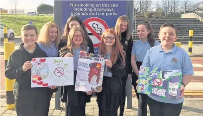  ??  ?? Pupils from Cyfarthfa High School outside Prince Charles Hospital with their anti-smoking artwork