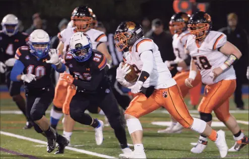  ?? H John Voorhees III / Hearst Connecticu­t Media ?? Ridgefield’s Ignacio Brina (9) cuts past Danbury’s Marcos Rodriguez (10) and Will Gordon (32) on his way to scoring a touchdown during a game on Nov. 25.