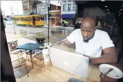  ??  ?? Sam Onwuchekwa, pastor of Fellowship Memphis’ Downtown outpost, works inside Bluff City Coffee on South Main, an area that mounted a comeback as an arts district.