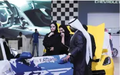  ?? — AFP ?? RIYADH: Saudi women look at a luxury sports car during the 30th Internatio­nal Riyadh Motor Show on Tuesday.