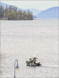  ?? Paul Buckowski / Times Union ?? Two people fish from a boat on the southern end of Lake George on Dec. 30. The Lake George Park Commission has adopted new regulation­s to protect the quality of the water.