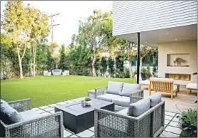  ??  ?? A PATIO with fire pit sits in the yard. The median single-family home price for the 90402 ZIP Code was $3.906 million in July.
