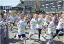  ?? BEN MOFFAT/THE REPUBLIC ?? Kids take off from the starting line during Pat’s Run near Wells Fargo Arena in Tempe.