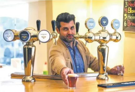  ?? Courtesy of Tarek Hbeichi ?? CU graduate Yazan Karadsheh, the 33-year-old founder of the Carakale Brewing Co., serves some of his craft beer in Jordan. Most Muslims believe alcohol is forbidden under Islam, and Jordan is more than 90 percent Muslim.