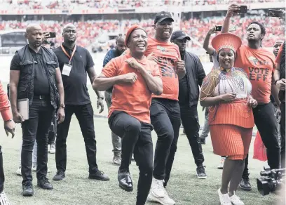  ?? Picture: AFP ?? HIGH SPIRITS. Julius Malema, centre, dances in front of party supporters as the EFF launched its electoral campaign at the Moses Mabhida Stadium in Durban on Saturday.
