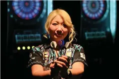  ??  ?? Japan’s Mikuru Suzuki -- known as “The Miracle” -- poses for a photograph in Tokyo. aescribed as the Phil Taylor of women’s darts, Japan’s Mikuru Suzuki already has plans to dominate the sport after becoming the first Asian player to capture a world title.