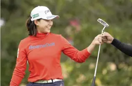  ?? ERIC GAY AP ?? Hinako Shibuno smiles after putting on the 17th green Friday during the second round of the U.S. Women's Open on the way to a 4-under 67 and a three-shot lead.