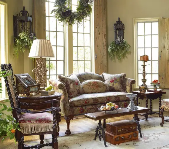  ??  ?? ABOVE In the sitting room, a 17th- century bookcase is lled with antique books and carvings. The chair in front has its original needlepoin­t and dates from around 1890. Opposite is a William-and- Mary chair with caned back. An Italian book from the mid...