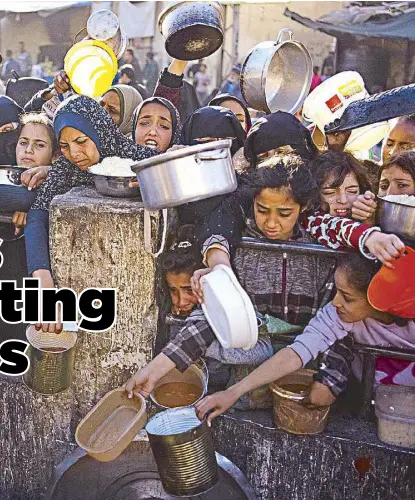  ?? THE PHILIPPINE STAR AP ?? Palestinia­ns line up for a free meal in Rafah, Gaza Strip in this March 12 photo.