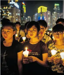  ?? s PHILIPPE LOPEZ, AFP/ Getty Image ?? People take part in a candleligh­t vigil in Hong Kong Monday to mark the 1989 Tiananmen Square massacre.