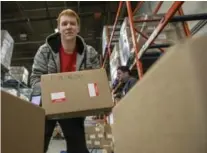  ?? BERNARD WEIL/TORONTO STAR ?? h the Daily Bread warehouse, sorts a box containing the can of tuna o another that will eventually be shipped to a community food bank.