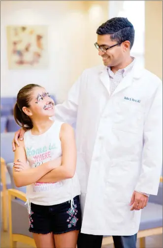  ?? SUN ?? allergist with the Yuma Regional Specialty Clinics, chats with a young patient. He was impressed that when the hospital was recruiting him, they wanted him for the community. The hospital offered him support whether he joined a private physician...