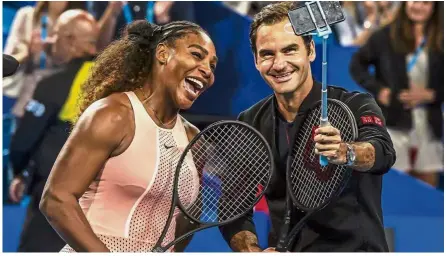  ?? — AFP ?? Fun time: Serena Williams of the US (left) and Roger Federer of Switzerlan­d take a selfie after their mixed doubles match at the Hopman Cup in Perth on Monday.