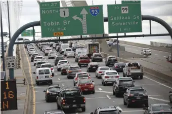  ?? NICOLAUS CZARNECKI PHOTOS, ABOVE AND LEFT / HERALD STAFF FILE ?? ALL TIED UP: Traffic backs up on Interstate 93 north across the Zakim Bridge, above, and at South Hampton street, below. A telecommut­ing tax credit proposed by Gov. Charlie Baker, left, potentiall­y could take 25,000 cars off Greater Boston roads.