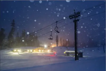  ?? CHRISTIAN PONDELLA — MAMMOTH MOUNTAIN SKI AREA VIA THE ASSOCIATED PRESS ?? In this photo provided by the Mammoth Mountain Ski Area, snow falls Jan. 22around a lodge and lifts in Mammoth Lakes.