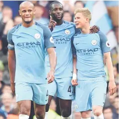  ??  ?? Manchester City’s Ivorian midfielder Yaya Toure (centre) speaks with Manchester City’s Belgian midfielder Kevin De Bruyne (right) after De Bruyne scored their second goal during the English Premier League football match between Manchester City and West...