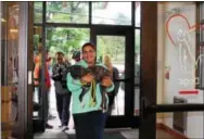  ?? SUBMITTED PHOTOS ?? Brandywine Valley SPCA volunteer Jeana Barr carries a dog displaced by Harvey.