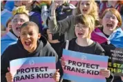  ?? AP PHOTO/TIMOTHY D. EASLEY ?? In March, protesters of Kentucky Senate Bill SB150, known as the Transgende­r Health Bill, cheer on speakers during a rally on the lawn of the Kentucky Capitol in Frankfort, Ky.