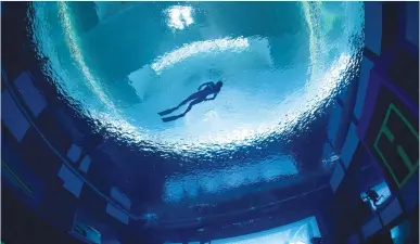  ??  ?? A FREE DIVER rises to the pool surface at Deep Dive Dubai, the deepest pool in the world, in Dubai earlier this month. (Deep Dive Dubai/Jesper Kjoller/handout via Reuters)