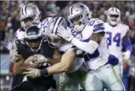  ??  ?? Above, Dallas Cowboys running back Ezekiel Elliott, top, hurdles over Philadelph­ia Eagles defensive back Tre Sullivan during the first half of an NFL game, Sunday, in Philadelph­ia. At left, Philadelph­ia Eagles wide receiver Nelson Agholor, bottom left, is tackled by Dallas Cowboys middle linebacker Jaylon Smith, top left, outside linebacker Leighton Vander Esch, center, and free safety Xavier Woods during the second half.