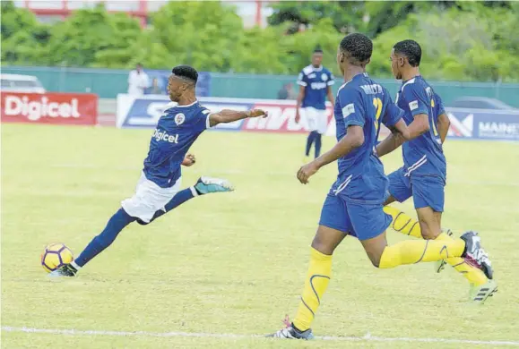  ??  ?? ISSA schoolboys football first game sees Jamaica College’s Norman Campbell (left) about to score a goal for his team during their Manning Cup Zone F game against Hydel High at Montego Bay Sports Complex.