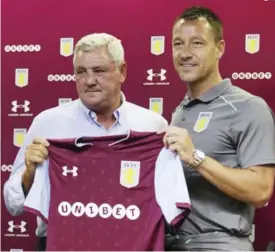  ??  ?? BIRMINGHAM: New Aston Villa signing John Terry, right, with Manager Steve Bruce during the media conference at Villa Park, Birmingham, England, yesterday. Former England and Chelsea captain John Terry has signed a one-year deal with second-division...