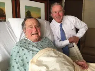  ?? Associated Press ?? This April 20 file photo provided by the Office of George H.W. Bush shows former President George H.W. Bush, left, posing with his son, former President George W. Bush, at Houston Methodist Hospital, where he was recovering from a mild case of...