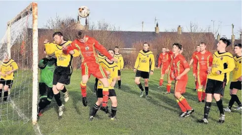  ??  ?? Nathan Lewis (red) on the attack for Bryngwran Bulls against Valley. Picture: WYNNE EVANS