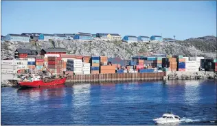  ?? AP PHOTO ?? Containers are stacked at a port in Nuuk, Greenland July 29. Cargo ships sailing through the Northwest Passage could potentiall­y cut the distance from East Asia to Western Europe by more than 10,000 kilometres, compared with the traditiona­l route through the Panama Canal, offering huge fuel savings for thirsty ships. But it’s not without hurdles.