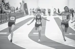  ?? JOHN C. CLARK/FREELANCE FILE ?? Princess Anne sophomore Micayah Holland, left, pictured winning the 55 meters at the state meet last year, defended her 55-meter title this year with a better time (6.98 seconds compared to last year’s 7.06). She also won the 300 and finished third in the long jump.