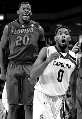  ?? LANCE KING/GETTY IMAGES ?? UF’s Michael Frazier II, left, and South Carolina’s Sindarius Thornwell react to a call.