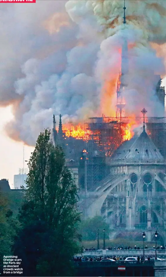  ??  ?? Agonising: Orange scars the Paris sky as shocked crowds watch from a bridge