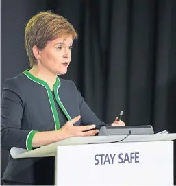  ?? Main picture: Mhairi Edwards. ?? Top: Army personnel were called to the 2 Sisters plant in Coupar Angus and have been spraying disinfecta­nt around the premises. Above: First Minister Nicola Sturgeon addresses yesterday’s press conference at Holyrood.