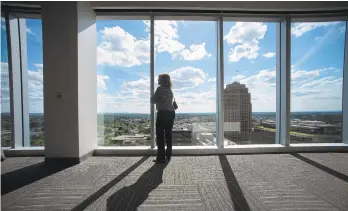  ?? PHOTOS BY RICK KINTZEL/THE MORNING CALL ?? A woman takes in the view on the 14th floor at Five-City Center Wednesday in Allentown, with the PPL Building in the background. The Lehigh Valley Economic Developmen­t Corp. hosted an event at Five City Center on Wednesday evening and visitors got a first glimpse inside downtown’s newest office tower and also listened to a panel discussion on attracting and retaining employees.