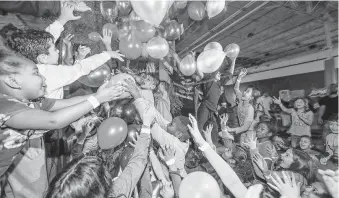  ?? Steve Gonzales / Staff photograph­er ?? More than 200 children enjoyed an 8 p.m. balloon drop during the New Year’s Eve Glow Light party on Monday at Altitude Trampoline Park in Sugar Land.