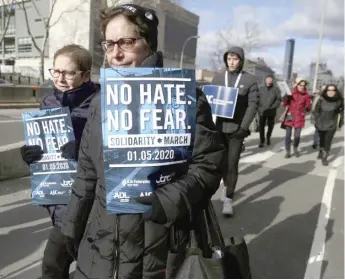  ?? AP ?? People march over the Brooklyn Bridge on Sunday during a rally against anti-Semitism.