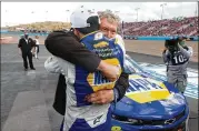  ?? RALPH FRESO/ AP ?? Chase Elliott hugs his father, Bill ( facing camera), after winning the season championsh­ip Sunday in theNASCAR Cup Series finale inAvondale, Ariz.